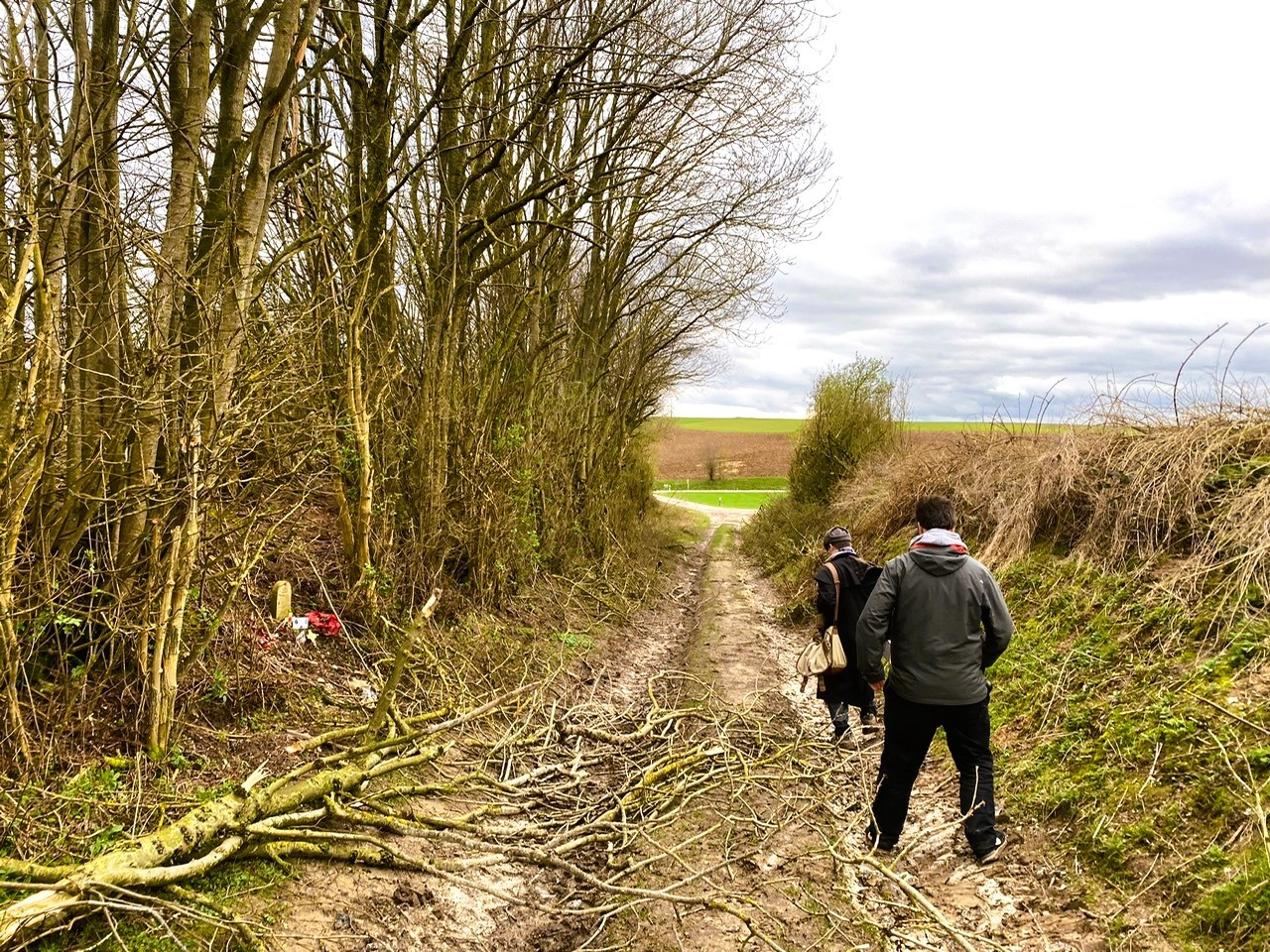 Mark and group member walking down muddy track