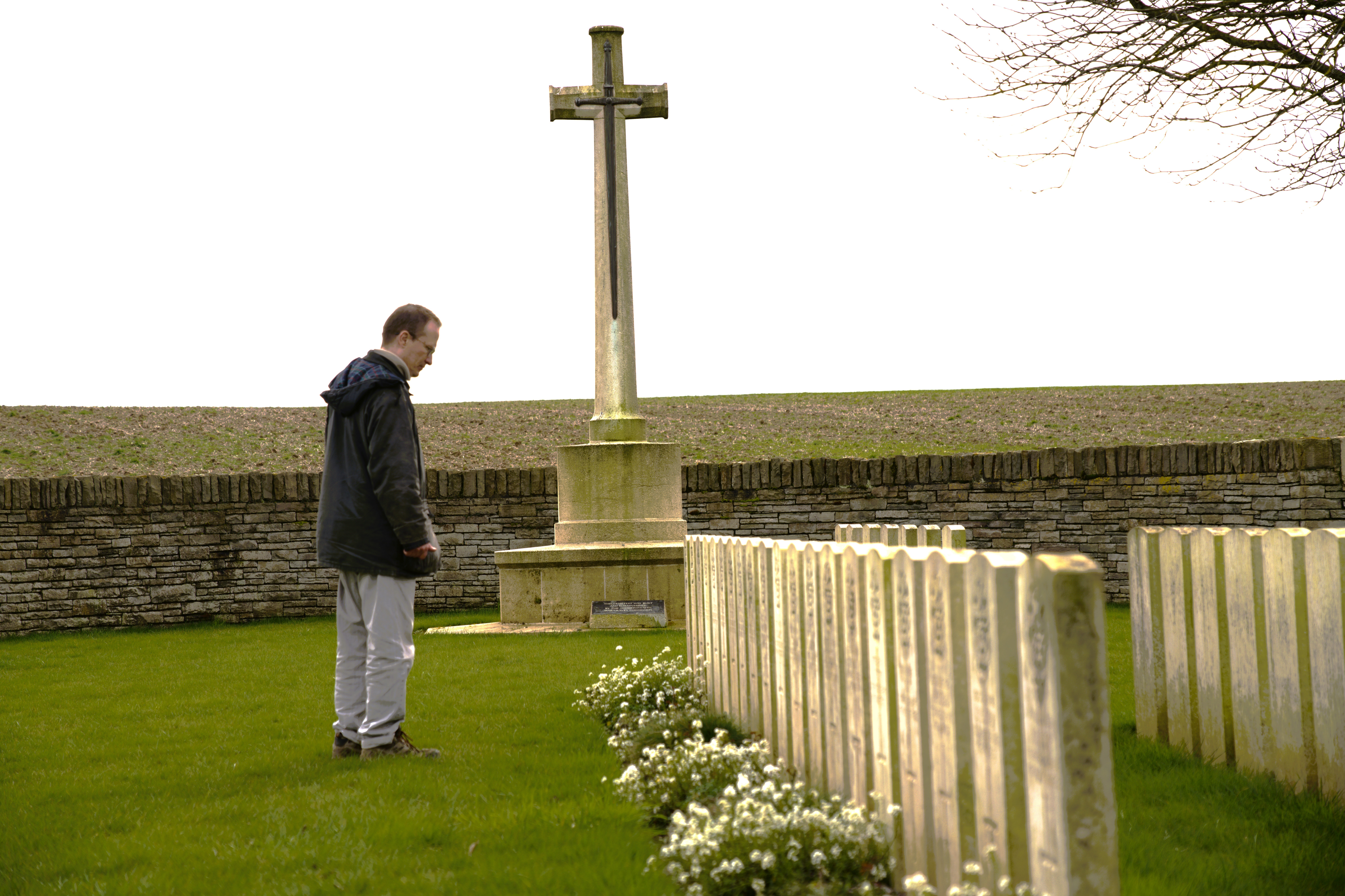 Mark looking at headstones in Owl Trench cemetery